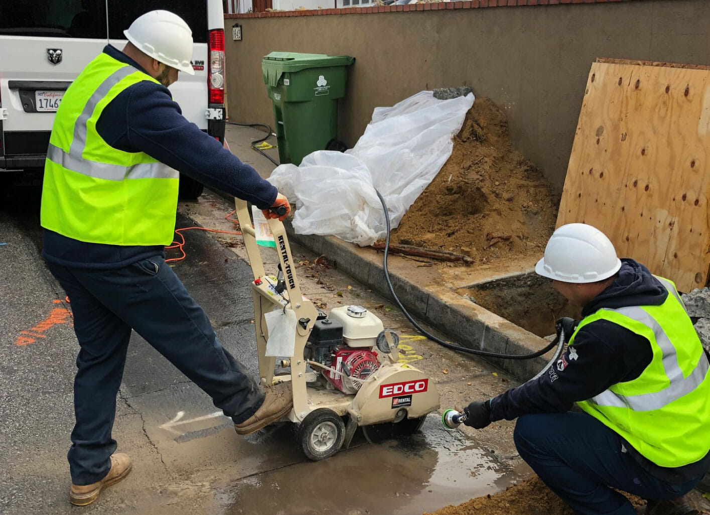 Flood Brothers crew cutting concrete to reach a sewer line