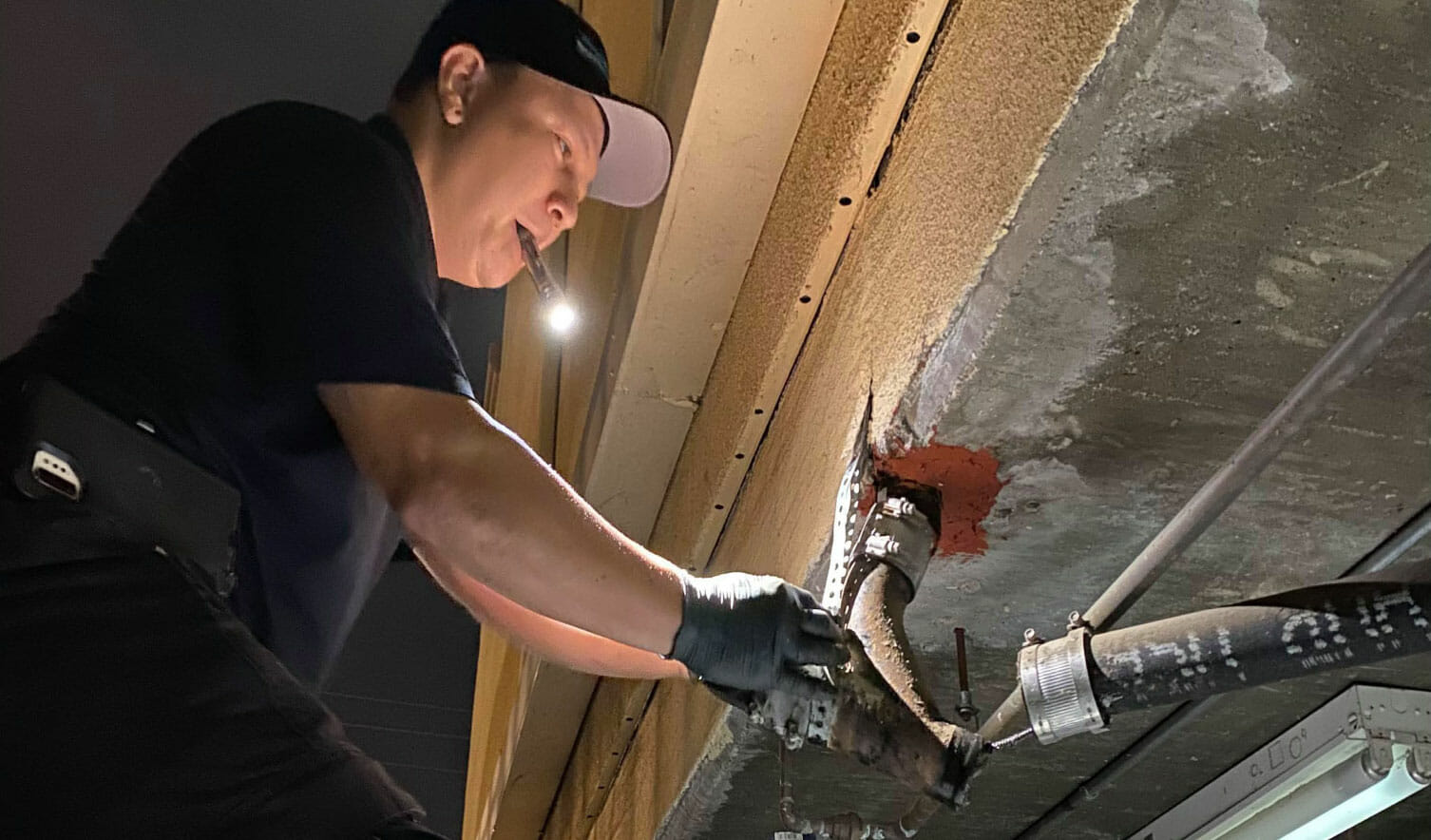 Flood Brothers plumber repairing a supply line