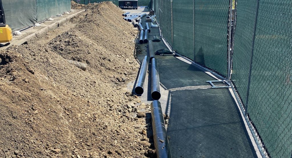 Large black metal pipes laid on the ground