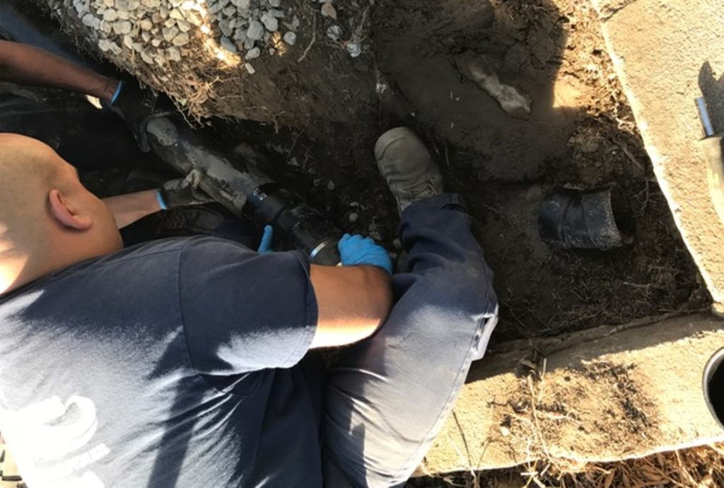 Plumber working on a undergrond water pipe