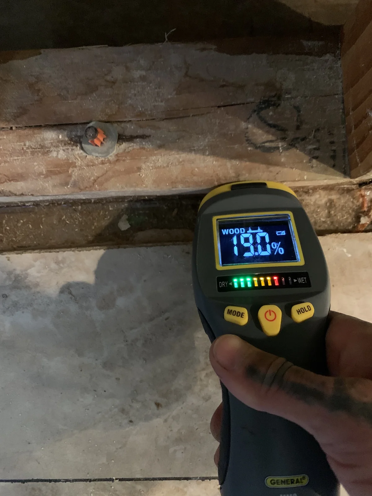Moisture meter reading on wet framing after a pipe leak